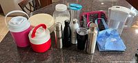 Group view of all containers, jugs, lunch bags and BRITA pitcher on countertop