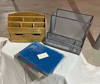 Bamboo organizer, mesh sorter, stack of plastic folders on table
