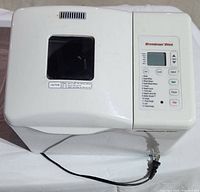 Top view of Breadman Plus bread maker showing control panel, window, power cord