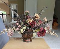 Full view of silk floral arrangement in ornate urn