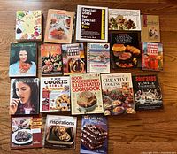 All 18 cookbooks laid out on floor
