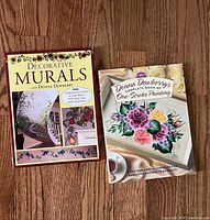 Front covers of both Donna Dewberry instructional books on wood floor