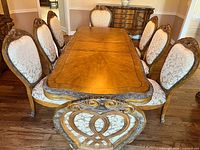 Dining table with eight chairs and buffet visible