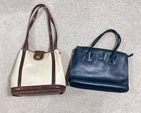 Overall view of both handbags on floor