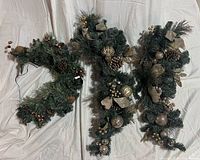 Three artificial pine swags showing size and design