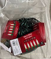 Three Merry Brite boxed light sets and tangled green wire lights