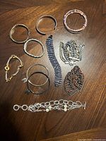 All fourteen bracelets laid out on wooden surface