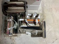 Overhead of two clear plastic bins and one wood crate filled with upright vinyl records