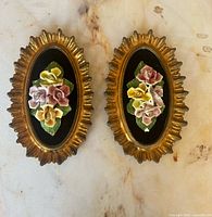 Pair of gold oval plaques with porcelain roses