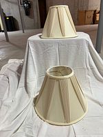 Both lamp shades front view showing pleated design and differing orientation