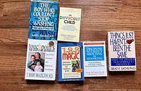 All six paperback titles laid out on wooden surface