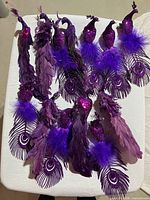 All 13 purple peacock ornaments displayed together