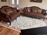 Sofa and loveseat on area rug showing full set
