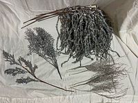 Overview of assorted silver and iridescent glitter floral picks and branches