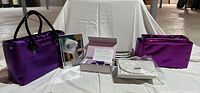 All items laid out: purple tote, organizer insert, LED mirror, boxed cleansing brush, white pouch