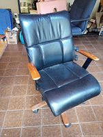 Front view of chair showing upholstery and wooden armrests