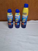 Three Coppertone Sport SPF 30 spray cans grouped