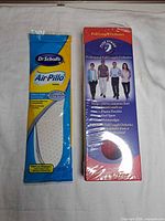 Front view of both sealed packages: Dr. Scholl's Air-Pillo and Pure Stride orthotics