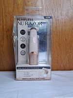 Front view of sealed Finishing Touch Flawless Nu Razor package