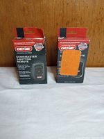 Front view of both boxed remotes