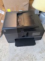 Front angled view of HP OfficeJet Pro 8620 printer showing touchscreen and output tray