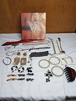 Full lot laid out with Victoria’s Secret box and assorted jewelry pieces
