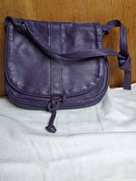 Front view of purple leather crossbody bag