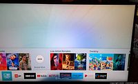 Front view of TV powered on showing Smart Hub home screen