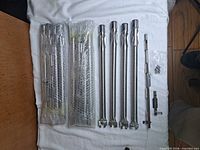 All contents: three bubble-wrapped packs, four unwrapped burner tubes, hardware bag and crossover tube