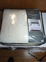 Front view of comforter in zip case showing brand, size and product image