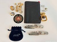 Overview of all items including buttons, pins, patch, passport case, corkscrews and pouch