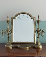 Front view of brass mirror with candle holders
