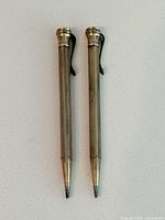 Two rolled gold mechanical pencils side by side front view