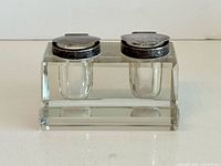 Front view showing crystal base and two inset wells with silver lids