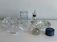 All eight glass and metal decorative items grouped