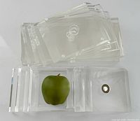Overhead view of all lucite pieces; green apple for scale