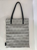Full view of tote bag front showing pattern and handles
