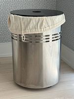 Full view of hamper showing stainless body, lid, liner and vent slots