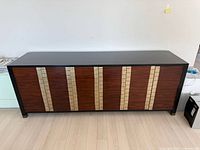 Full front view of media cabinet showing striped veneer door design and overall size