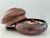 Open copper bowl with lid offset showing sand garden contents