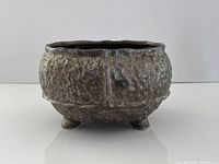 Front view showing textured surface and footed base