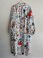 Full front view of white floral Erdem linen dress on hanger