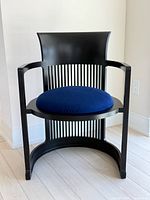 Front view showing overall design, arms, cushion, and slat backrest