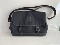 Front view of Longchamp messenger bag showing overall design and shoulder strap