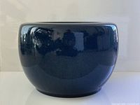 Front view of glossy dark blue ceramic planter