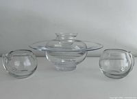 Front view of glass bowl-vase with two mugs