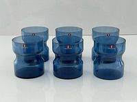 Front view of six blue Iittala tumblers