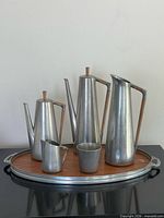 Full set of five pewter vessels on oval tray