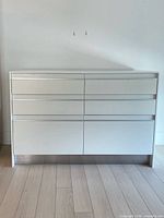 Full front view of white 6-drawer sideboard