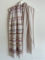 Scarf draped on hanger showing full stripe pattern and solid reverse
